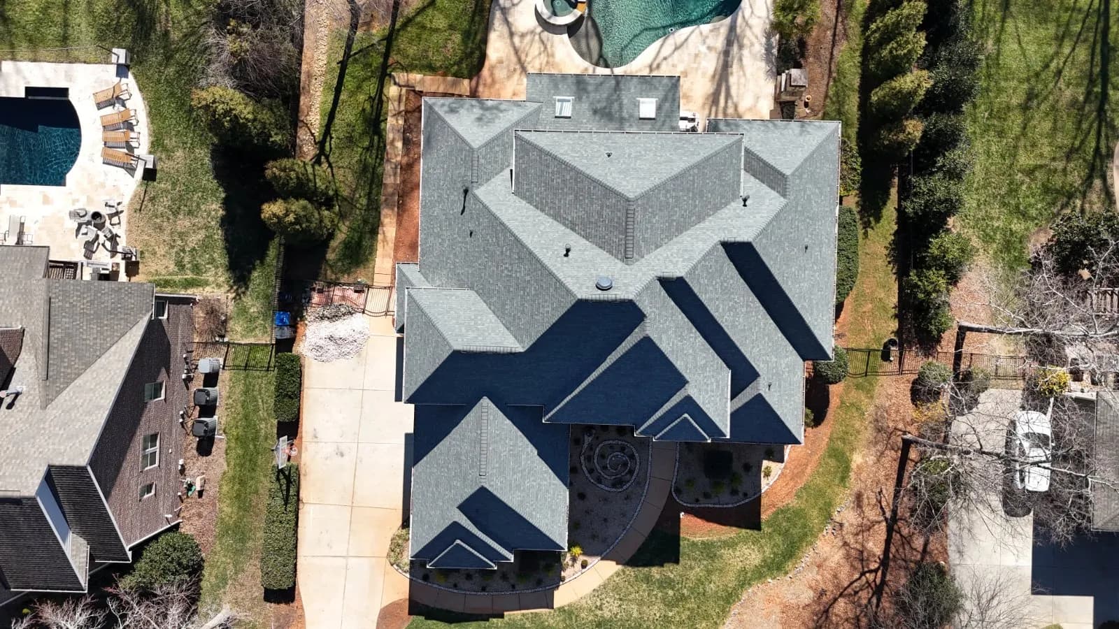 Roofing contractor in Greensboro, NC, reviewing repair plans on a digital tablet with a local homeowner.