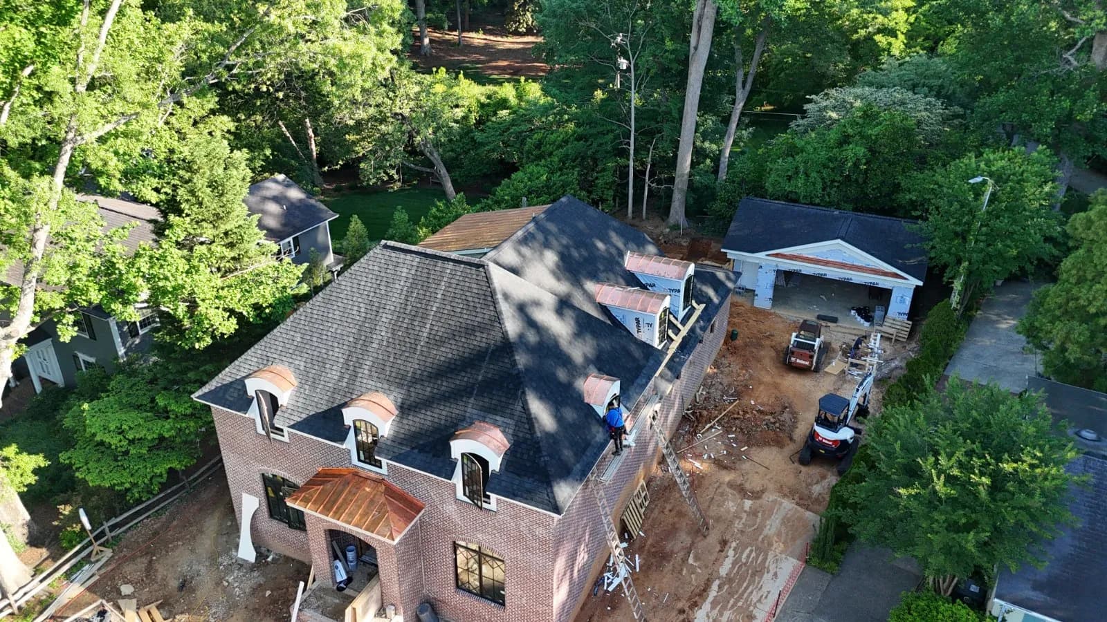 Manchester Roofing crew on a roof installation in Greensboro